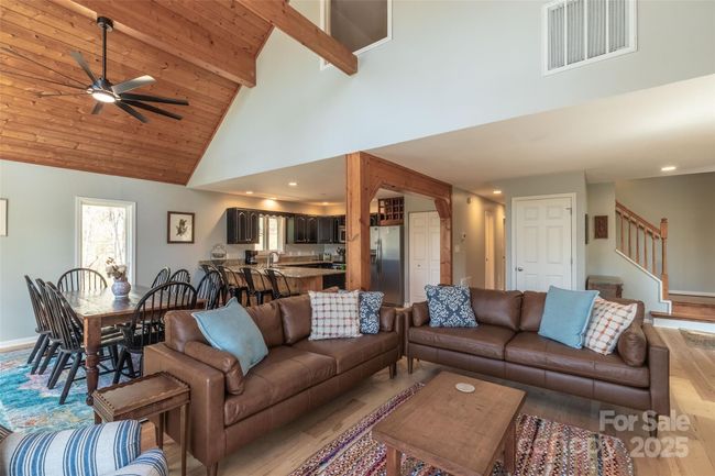 Living space with wood accents on ceiling | Image 25
