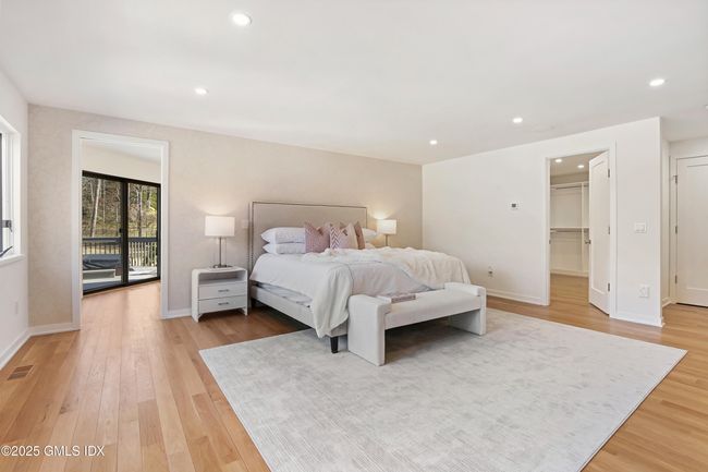 View details the depth of the primary bedroom, walk-in-closet, separate shoe closet up to 70 pairs, and sep dressing room/office, with view of hot tub on private deck | Image 26