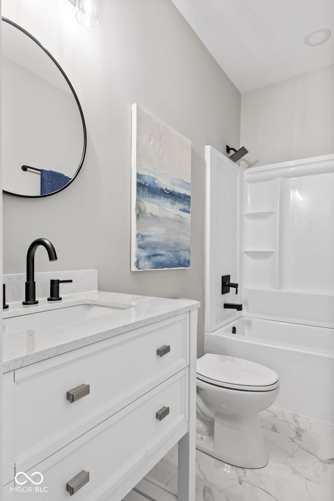 full bathroom featuring marble finish floor, toilet, vanity, and bathtub / shower combination | Image 34
