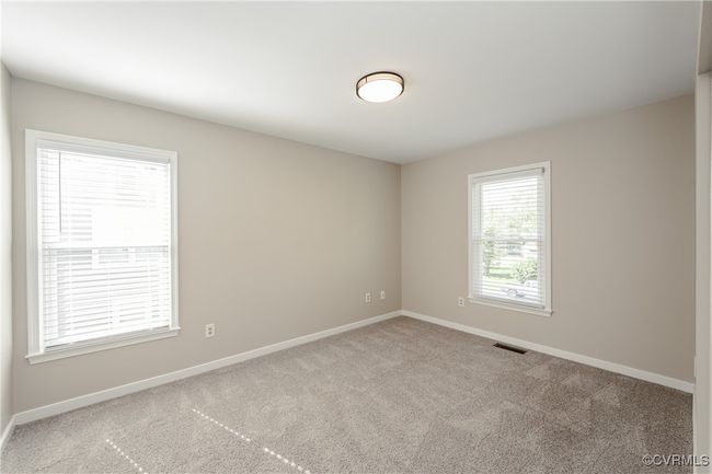 Bedroom 4 Carpeted spare room with baseboards and visible vents | Image 40