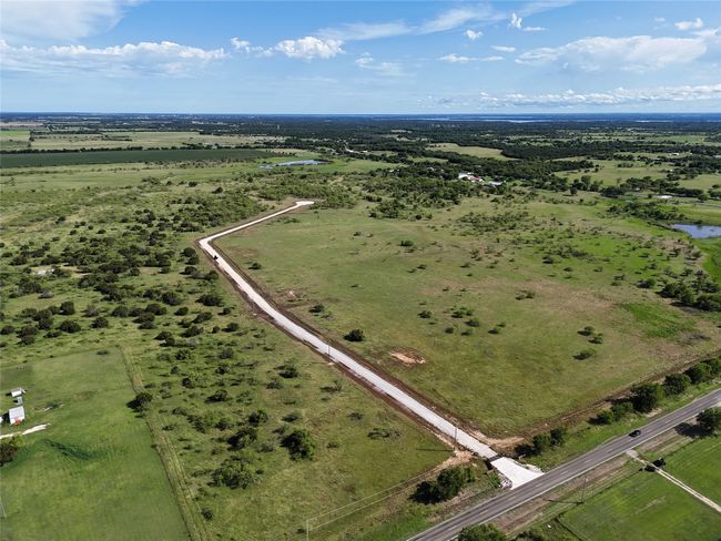 Aerial overview of property's location with a large body of water and rural landscape | Image 4