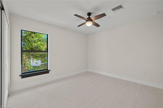 Spare room with ceiling fan | Image 32