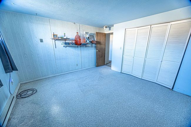 Unfurnished bedroom featuring a textured ceiling and a closet | Image 33