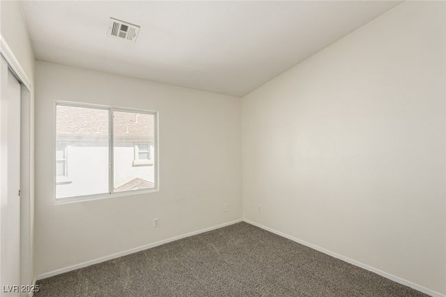 Unfurnished room with baseboards, dark carpet, and visible vents | Image 18
