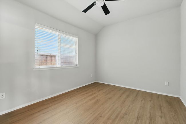 Unfurnished room featuring wood finished floors, a ceiling fan, and vaulted ceiling | Image 22