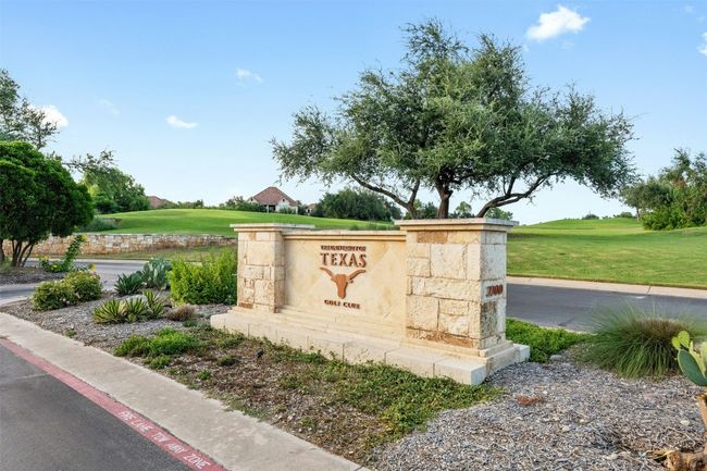 Community / neighborhood sign with a yard and golf course view | Image 25