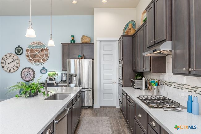Kitchen toward pantry door. | Image 12