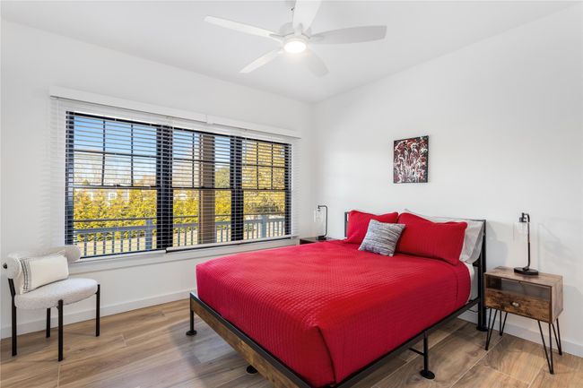 Bedroom with multiple windows, baseboards, and wood finished floors | Image 14