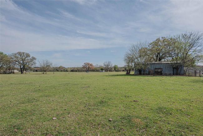View of yard featuring an outbuilding, a rural view, and a pole building | Image 30