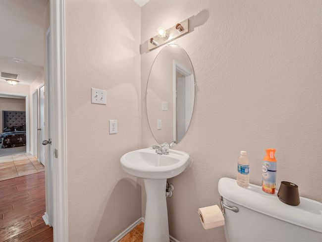 Half bath featuring toilet and wood finished floors | Image 29