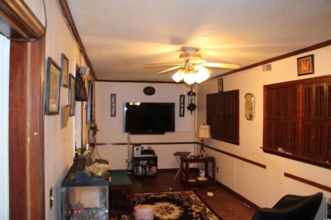 Living area with crown molding and ceiling fan | Image 10