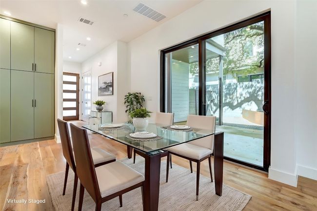 Dining area with plenty of natural light, light wood finished floors, recessed lighting, and baseboards | Image 9