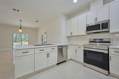 Gorgeous kitchen with stainless steel appliances and quartz countertops! | Image 2