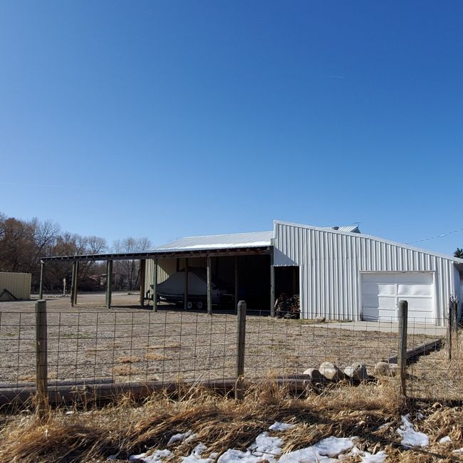 North end of property shows covered parking and garage | Image 9