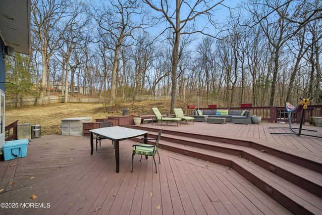 LARGE deck with privacy & nature with sliders to spacious living room & eat in Kitchen with separate Dining, Coffee bar, SS appliances and laundry room! | Image 14