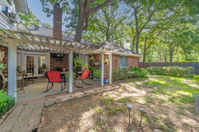 View of yard featuring french doors, a pergola, and a patio area | Image 24
