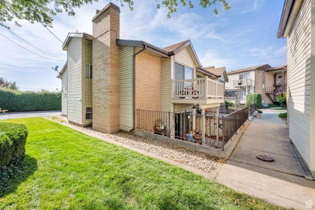 Rear view of house featuring brick siding and a chimney | Image 13