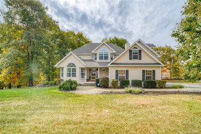 View of front of property featuring a front yard and covered porch | Image 1