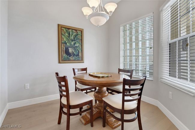 Dining area with a chandelier and light wood finished floors | Image 6