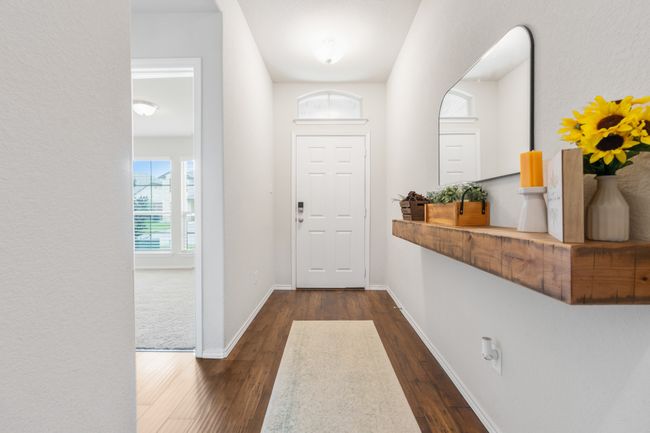 Doorway to outside with dark wood finished floors and baseboards | Image 7