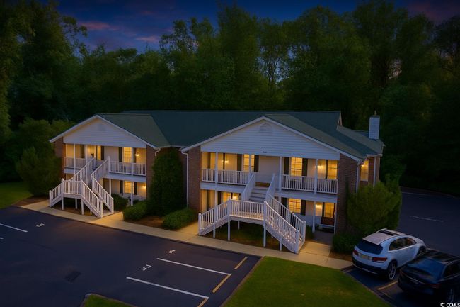 Rear view of property featuring stairway, a porch, and uncovered parking | Image 39