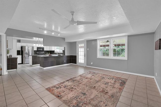 Large open space open to the kitchen. Half bath and entrance to the garage is to the left of the POV | Image 9