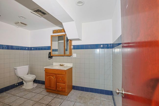 Bathroom with toilet, tile patterned floors | Image 20