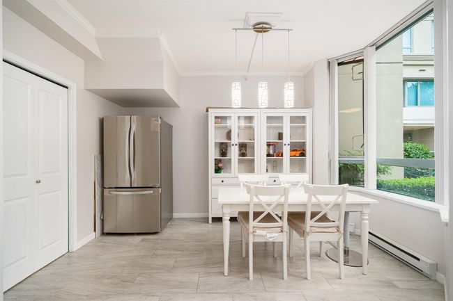 Dining room featuring a baseboard heating unit and crown molding | Image 10