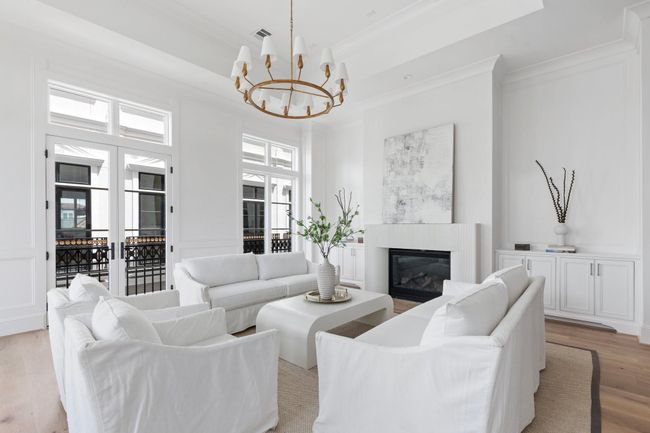 With soaring ceilings, tall windows, and intricate wall paneling, this living space evokes the elegance of a Parisian apartment—refined, light-filled, and quietly luxurious. | Image 12