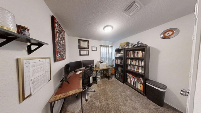 Office area with carpet and a textured ceiling | Image 31