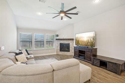 Living room with light wood-type flooring, lofted ceiling, and ceiling fan | Image 3