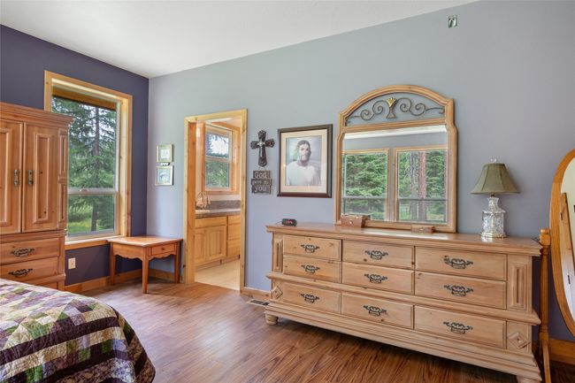 Bedroom with light wood finished floors and connected bathroom | Image 42