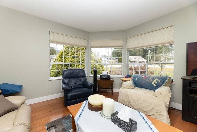 Interior space with baseboards and wood finished floors | Image 7