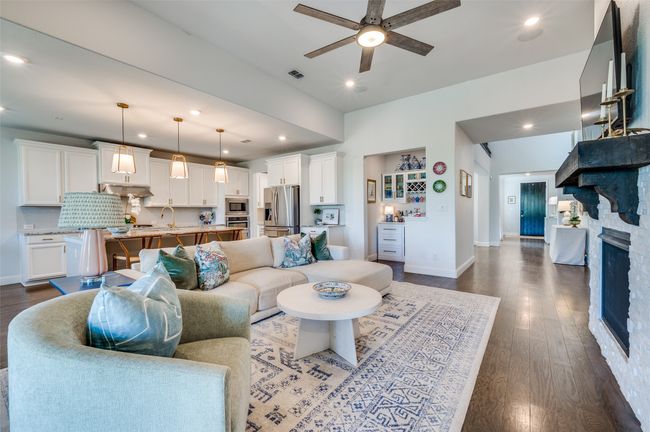 Enjoy entertaining with this spacious living room that is open to the kitchen and nestled just off the living room is an extra space for a bar or desk. | Image 15