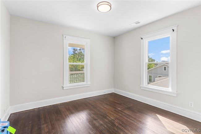 Unfurnished room featuring baseboards, visible vents, and dark wood finished floors | Image 29