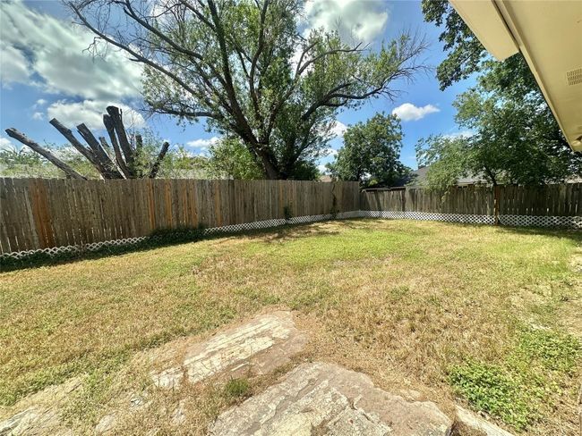 View of fenced backyard | Image 18