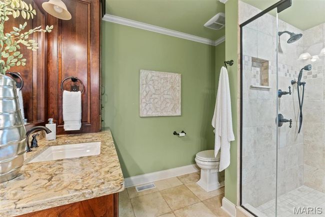 Full bathroom featuring ornamental molding, vanity, a stall shower, and tile patterned floors | Image 42