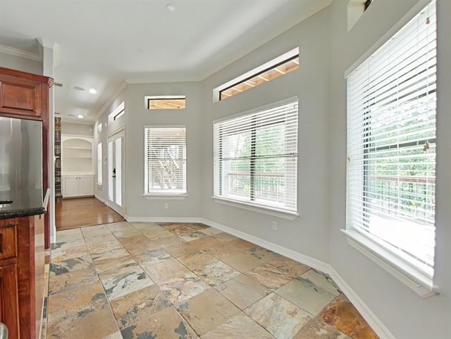 Breakfast area at the end of the kitchen island with tons of natural light and a peaceful view. | Image 9