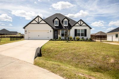 View of front facade featuring a front lawn and a garage | Image 2