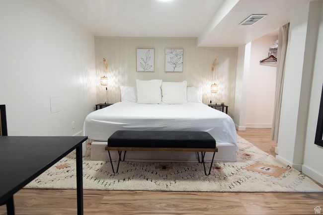 Bedroom with wood finished floors and baseboards | Image 27