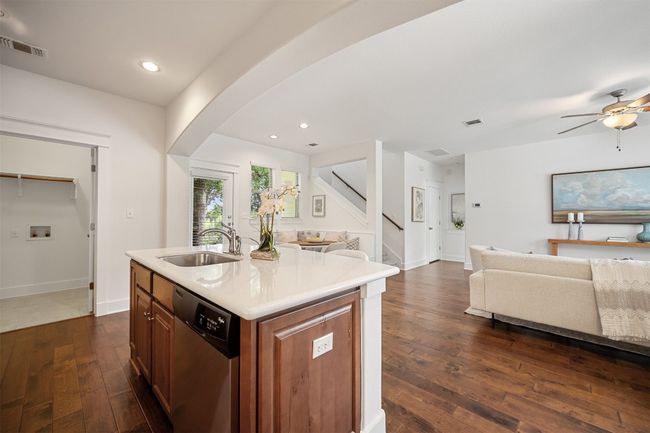 The kitchen overlooks the living room, creating a seamless connection between spaces, perfect for entertaining or keeping an eye on everyone while preparing meals | Image 16