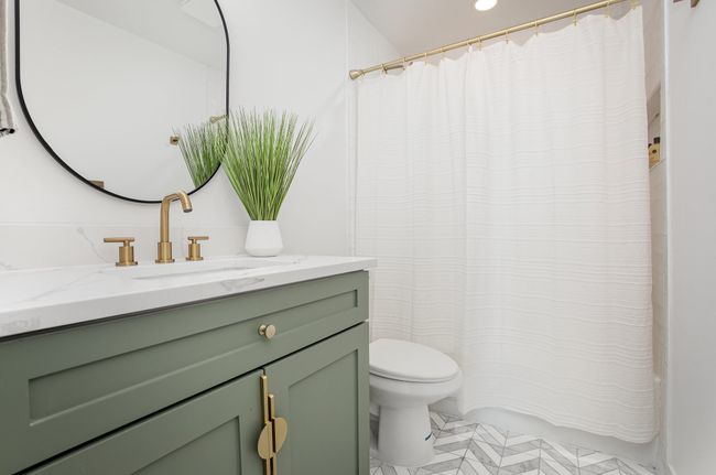 Bathroom featuring recessed lighting, shower / bathtub combination with curtain, vanity, and toilet | Image 27