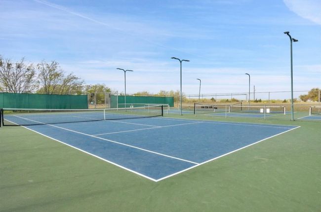 View of tennis court with fence | Image 25