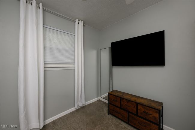 Unfurnished bedroom with carpet and a textured ceiling | Image 13