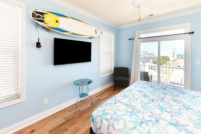 Bedroom with ceiling fan, wood finished floors, visible vents, baseboards, and ornamental molding | Image 21