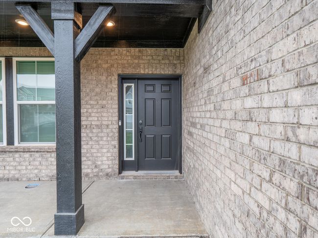 view of exterior entry with brick siding | Image 7