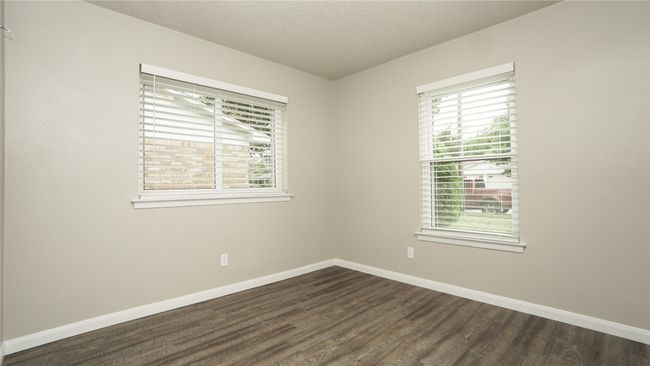 Bedroom 3 has two windows and lighted ceiling fan | Image 18
