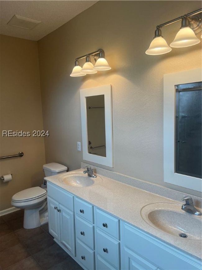 Bathroom featuring vanity, toilet, and tile patterned flooring | Image 19