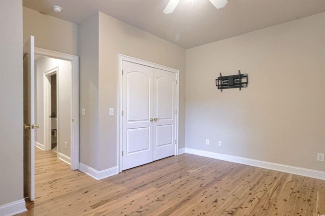 Unfurnished bedroom featuring light wood-type flooring, a closet, and a ceiling fan | Image 16