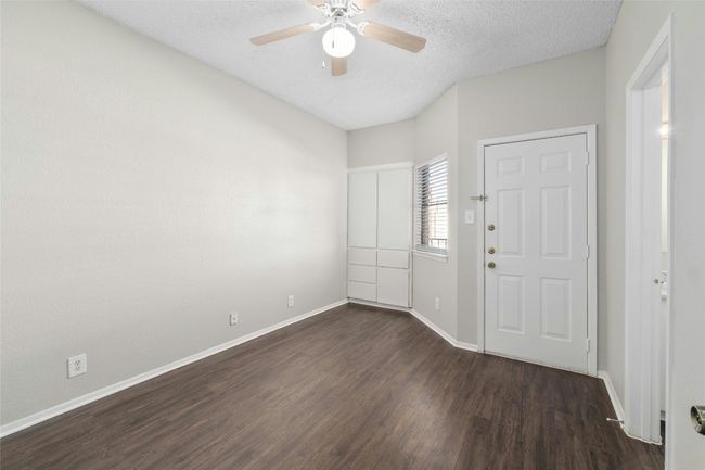 Entrance foyer with dark wood-style flooring, ceiling fan, a textured ceiling, and baseboards | Image 16